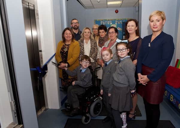 Mayor Michaela Boyle with pupil Jack Mullan preparing to cut the ribbon to officially open the Wheelchair Accessible Lift in St. Anne's PS. Included, from right, are Patricia McNutt, vice-principal, Eilis McGuinness,, principal, Kerry Lynn Mullan, Eilish Friel, Parents Association, Louise Gallagher, Karen Mullan, MLA, and John Paul Mullan. Front are pupils Brannagh McGeehan and Oran Logan-Doyle. (Photo - Tom Heaney, nwpresspics)