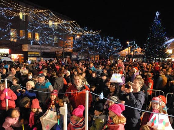 Crowds gather for the switching on of Christmas lights at Broadway in Larne (archive image).  Details of the switch on ceremonies across Mid and East Antrim have been released.