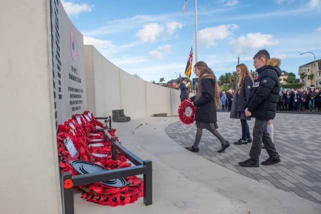 Young members of the community taking part in the wreath-laying ceremony at the new Whitehead war memorial.