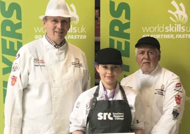 Codie-Jo Carr receives her certificate from judges Roger Kelsey and Viv Harvey in the regional heat