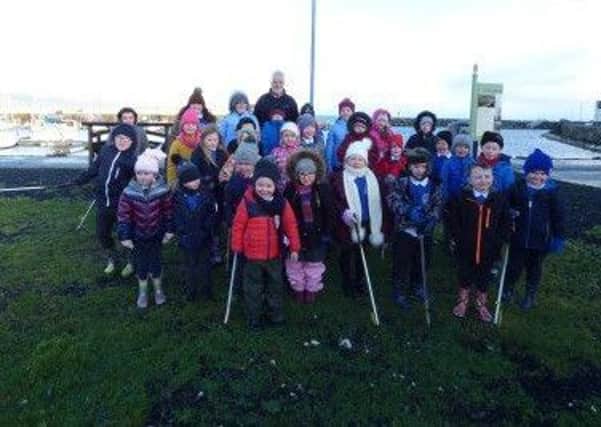 Children from Carnalbanagh Primary School with Billy McCauley, Harbour Master at Glenarm Marina where they carried out a litter pick earlier this year.