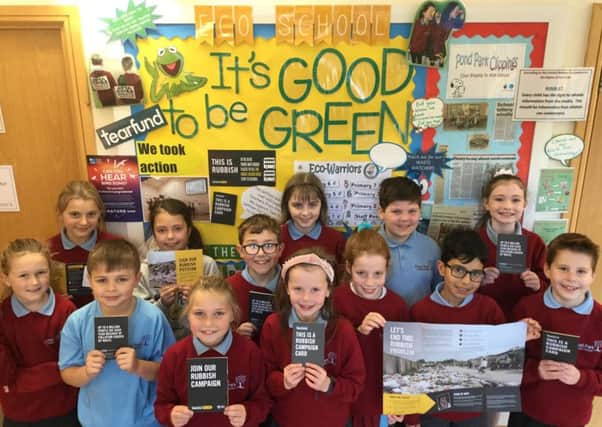 The Eco Council in front of their notice board with Tearfunds Rubbish Campaign literature. Pic by Emily Coulter/Pond Park Primary School