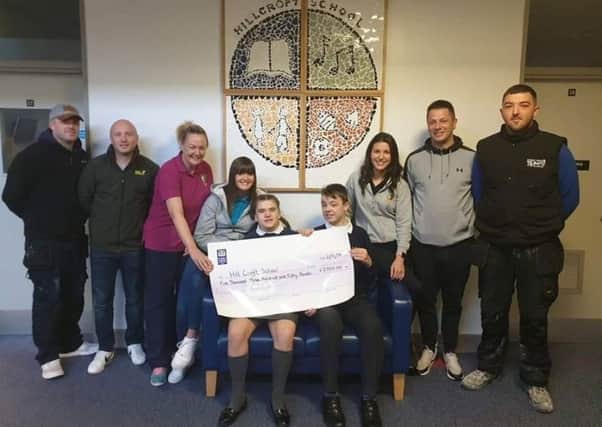 Members of Rathcoole Protestant Boys presented the money to Hill Croft School.