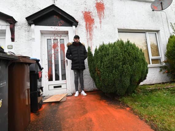 Sergiu Preda inspects the damage caused to his home in Newtownabbey. Photo Colm Lenaghan/Pacemaker