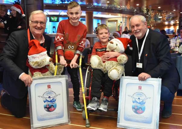 Oliver Dickey and Ethan Pollock are pictured with Colin Barkley, Chair, Northern Ireland Children to Lapland & Days To Remember Trust (NICTL) and Gerry Kelly