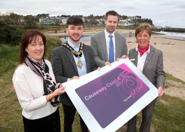 The Mayor of Causeway Coast and Glens Borough Council Councillor Sean Bateson helps to launch the new Causeway Coast and Glens Gift Card with Project Officer Catrina McNeill, John McGill from Ballycastle Chamber of Commerce and Harriet Hamilton from Ballycastle Visitor Information Centre