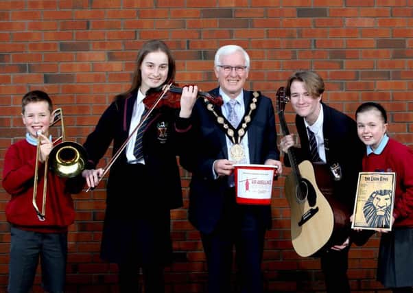 The Mayor, Councillor Alan Givan is joined by local school pupils: Gemma and Daniel from Pond Park Primary School and Julie and Owen from Wallace High School to promote the 'Fly Me to the Moon' concert to raise money for the Mayor's charity, Air Ambulance NI.