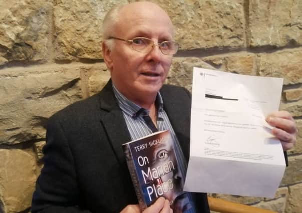 Author Terry Hickland with his book and letter he received from German Chancellor Angela Merkel