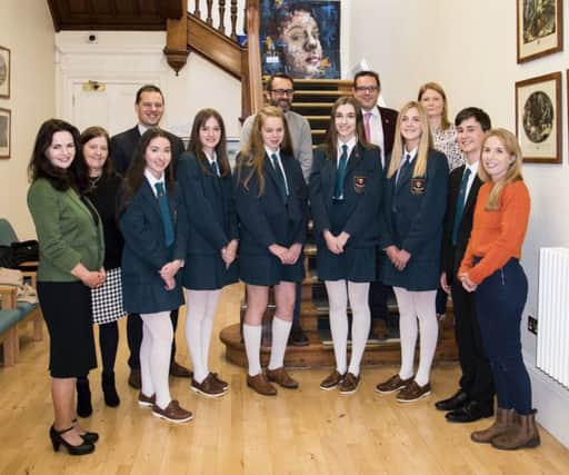 Mr McLoughlin alongside the pupils who were top candidates in GCSEs and their teachers.  From left to right the pupils are, Leah Donnelly, Susanna Elliott, Bethany Nixon, Susie Neill, Zara Ginniff and Jude Kennedy.  From left to right the teachers are Miss J Cosgrove, Mrs H Stewart, Mr R S McLoughlin, Mr G Robinson, Mr T Dempsey, Mrs G Johnston and Mrs S Tully
