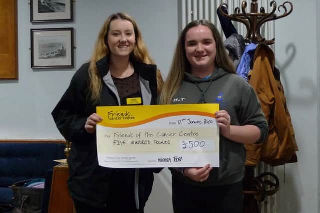 Hannah Todd, CAYC junior vice captain, presenting Amy, Friends of the Cancer Centre, with a cheque of £500.