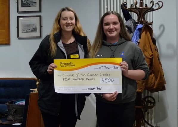Hannah Todd, CAYC junior vice captain, presenting Amy, Friends of the Cancer Centre, with a cheque of £500.