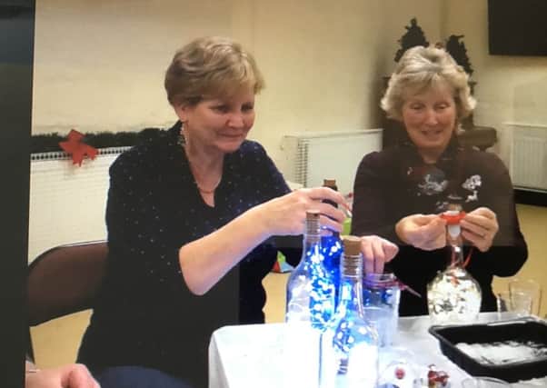 Pictured during Broughshane WI's Christmas Party last month  are Becky Smyth and Sally McBurney (left to right) who were practising decorating festive bottles following a demonstration on the art by Sandra Adams