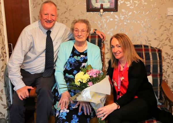 Housing Executive Maintenance Manager Frankie McBride and local Housing Manager Noeleen Connolly with Mrs Gillan when she celebrated her 100 th birthday