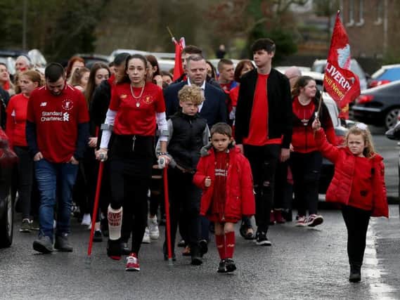 Fiancee of Nathan Gibson with his six year old son John walk behind his funeral cortege in