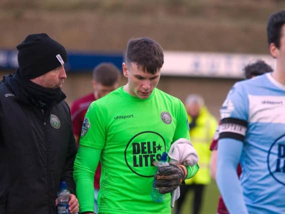 Warrenpoint Twon goalkeeper Mark Byrne leaves the pitch