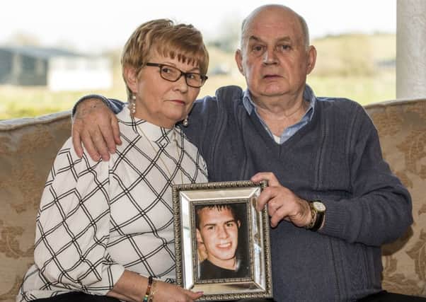 Stephen and Breege Quinn holding a picture of their murdered son Paul Quinn at their home near Cullyhanna Co. Armagh. Liam McBurney/PA Wire