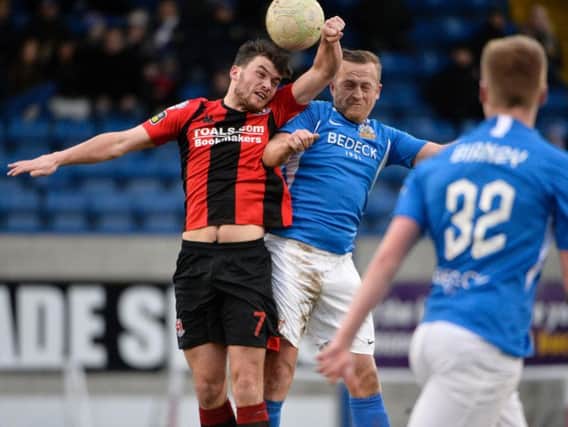 Crusaders' Philip Lowry (left) competing with Sammy Clingan of Glenavon at Mourneview Park