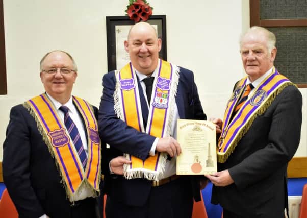 Brother Derrick Stewart (centre) receiving his Past Masters Certificate and Collarette from Worshipful Brother Gordon McCrory, Worship District Master, Ballymena District L.O.L. No.8 (left) and Right Worshipful Brother Robin Mathews, Right Worshipful County Grand Master, County Antrim Grand Orange Lodge