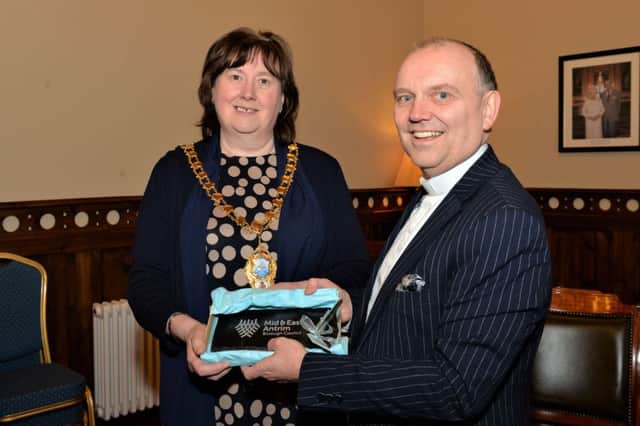 The Mayor of Mid and East Antrim Borough, Councillor Maureen Morrow, presents a gift to Rt Rev Dr William Henry, Moderator of the Presbyterian Church, during his visit to Larne Town Hall. INLT 05-002-PSB