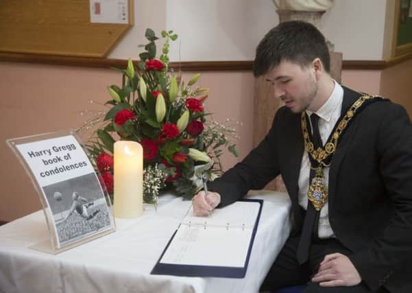The Mayor of Causeway Coast and Glens Borough Council Councillor Sean Bateson signs a book of condolence in Coleraine Town Hall in memory of football legend Harry Gregg who passed away on Sunday, February 17 aged 87. The book will be open to the public in Coleraine Town Hall until Monday, March 2
