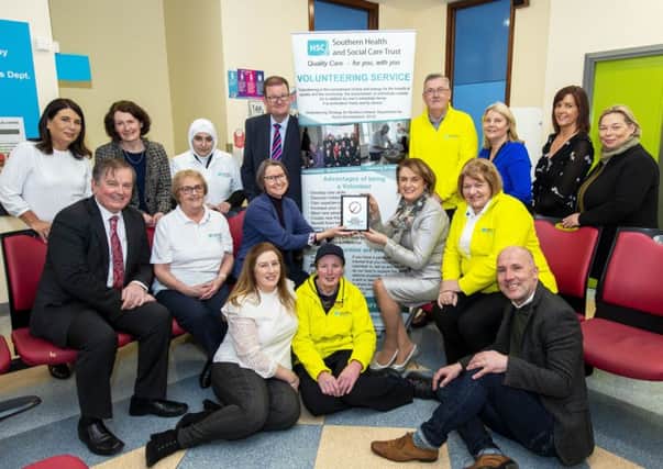 Denise Hayward, Chief Executive of Volunteer Now presents the
Investing in Volunteers award to Chair Roberta Brownlee. Also included:
Chief Executive Shane Devlin, Interim Director for Acute Melanie McClements, Interim
Director for Older People and Primary Care (OPPC) Brian Beatiie, staff from the Promoting
Wellbeing Team and volunteers with the Southern Trust.