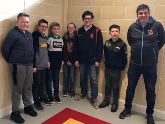 Carrickfergus Grammar principal James Maxwell with pupils from the school, all of whom enjoyed playing in their first ever chess competition.
