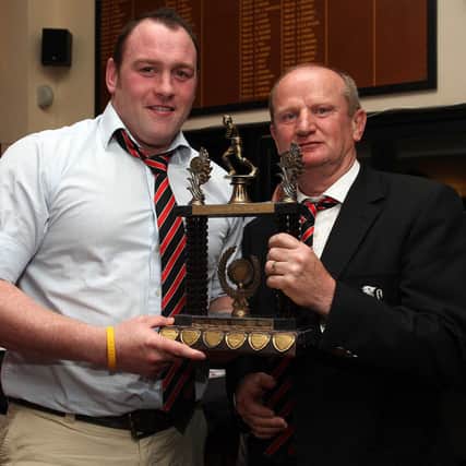 1st XV Player of the Year Neil O Kane with his award from Rainey club President Martin Eastwood.mm20-349sr