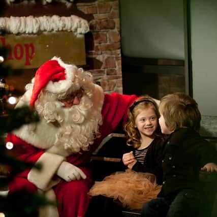 Keely and Davin McKeown meeting Santa in his Magicial Grotto at the Burnavon Cookstown. INMU4812-057X