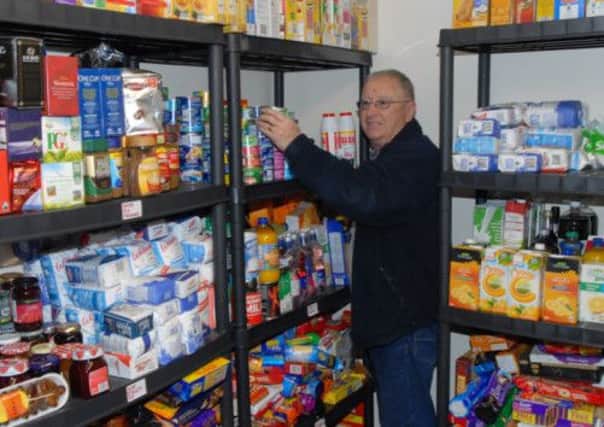 Alan Turner stacking the shelves at Craigyhill Methodist Church for Foodbank. INLT 10-388-PR