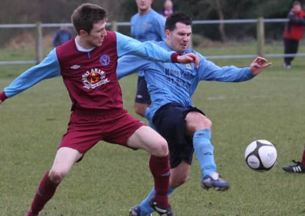 Newbuildings United's Gareth Falconer, contesting the ball with Ards Rangers defender Jackie Kerr, during their Intermediate Cup quarter-final tie at Newbuildings. INLS1310-553MT