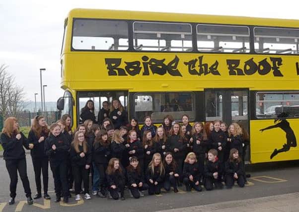 Raising the Roof Kids Choir with their new tour bus, about to leave from the Ballymena North Complex ready to take a wee trip around Ballymena Town Centre and then to Junction One, Antrim. INBT 10-862H