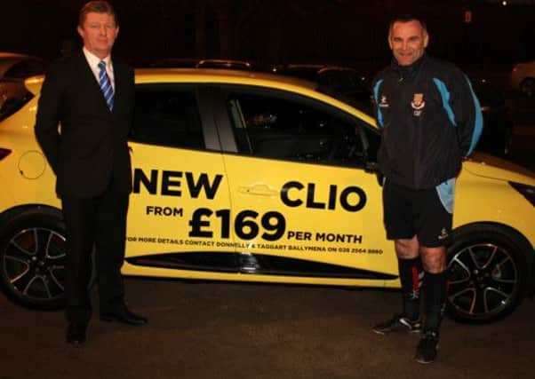 Darren Gardiner, of Donnelly Group, who sponsored Ballymena United's game against Glentoran on Saturday, shows United boss Glenn Ferguson a new Clio model. Picture: Reid McAuley.