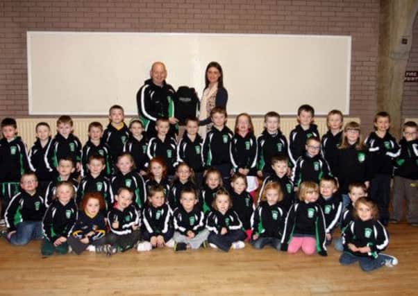 Sean McKay, coach of Con Magees GAC under 6's, is pictured receiving new sponsored sweatshirts from Johanna Montgomery, of Johanna Montgomery Designs. INBT07-225AC