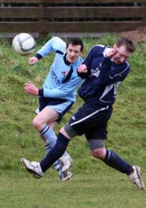 Randalstown Sky Blues player David Cameron crosses the ball in as Penarol's Nolan Logan dodges. INBT11-263AC