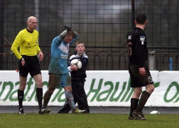 Ballymena United's David Cushley begins the long walk for the tunnel after being sent off by referee Colin Burns in Saturday's draw with Glentoran. Picture: Pacemaker Press.