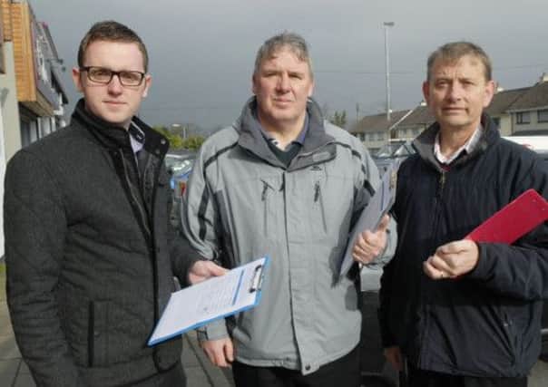 Collecting signatures for the petition in Newbuildings were, from left, Councillor Gary Middleton, Gordon Moore, Chairperson of the Newbuildings Community Association, and Alderman Maurice Devenney. INLS1113-151KM