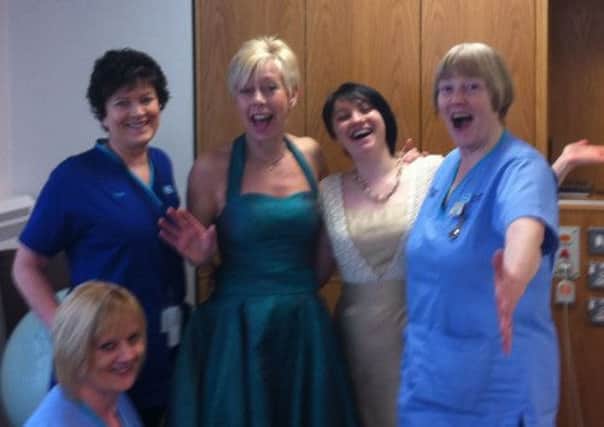Midwives at Lagan Valley trying on their dresses for the night.