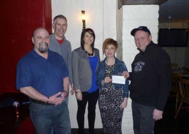 Left to right as follows. Paul Harrison, kevin Acum (Treasurer), Sonia Wilson, and David Guiney (Club Chairman) present a cheque to Lisa Brown for the Northern Ireland Cancer Fund for Children.