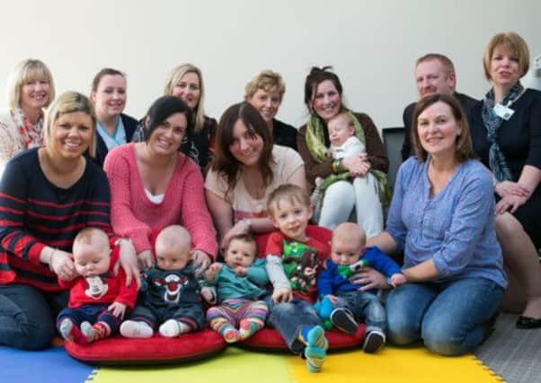 Kieran McNeill from Thunderdome Cafe presents Sinead Lynch, Northern Trust breastfeeding coordinator, and members of the Glengormley breastfeeding support group with two floor seats specially designed for new mothers. INNT 09-402-RM