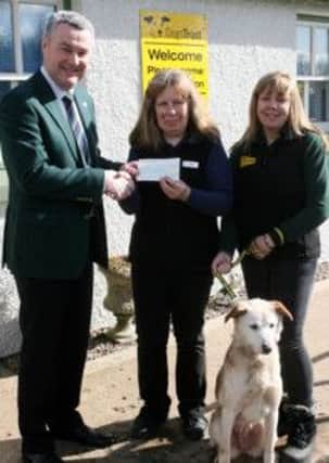 Lyle Foster, Captain of Galgorm Castle Golf Club, presents a cheque to Mary Kearney and Sandra Park of the Dogs Trust, proceeds of the clubs recent charity day. INBT12-224AC