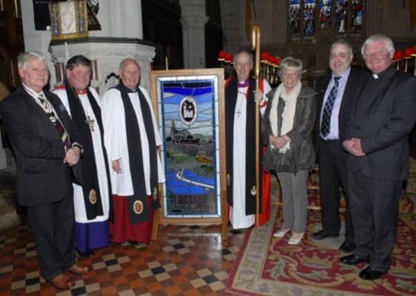 Pictured with the stained glass window which was dedicated in memory of The Very Rev George Good, Dean of Derry 1967-1984, during the Service of Thanksgiving to mark the 40th anniversary of The Cathedral Youth Club in St. Columb's Cathedral on Sunday were, from left, Alan Moore, Deputy Lord Lieutenant for the City of Londonderry, Dean William Morton, Dean Cecil Orr, Bishop Ken Good, Jeanette Warke, club leader, Chris McClintock, who designed the window, and Canon John Merrick. INLS1213-166KM