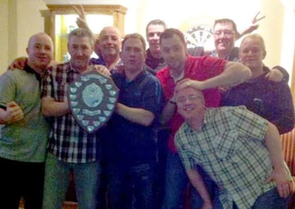 The Drumdor team celebrate after retaining their league trophy.