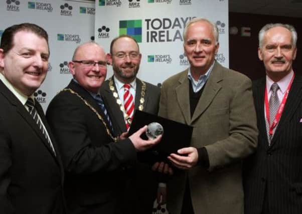 Founder & CEO of MHZ -Worldview Fred Thomas, presents a piece of crystal to the Mayor of Londonderry Councillor Kevin Campbell, at the announcement in  Seagate, Springtown plant,  of the City of Cultures participation in Todays Ireland television which will broadcast in Washington DC and through the USA on MHZ-Worldview Channel beginning on March 17th 2013. Included are Martin Bradley, chairman of City of Culture 2013, Londonderry Chamber of Commerce president Philip Gilliland and MHz - Worldview's UK & Ireland Representative Tony Culley-Foster.  INLS 1312-502MT.