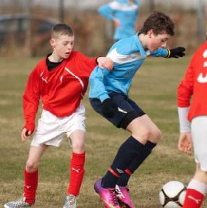 Institute's Jamie Adams pictured on the ball during their under-14's match against Cliftonville at Lisneal on Saturday. INLS1213-132KM