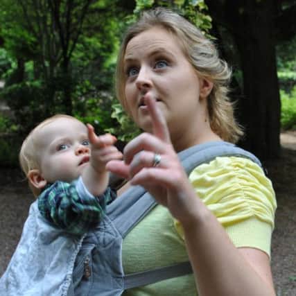 Dungannon mum, Claire Hackett, points out some of the sights to her son while wearing a baby carrier. INTT1213-054X