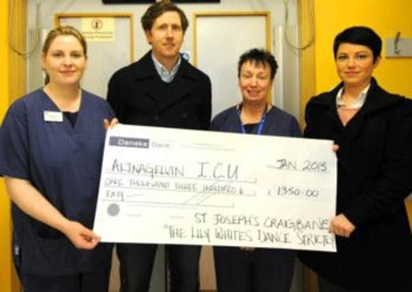 Ryan Coyle and Laura Cooke present £1,400 to Noreen Elliott and Caroline Harley at the Altnagevlin intensive care unit.