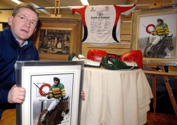 All Saints Boxing Club official Gerry Hamill shows of some of the top auction items that the club have received for next weeks event to be held in the Leighinmohr Hotel. INBT 13-814H