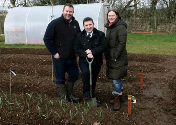 Robin Swann MLA pictured with Scott and Rebecca Edmundson of Lettuce Grow Allotments, Old Tullygarley Road. INBT13-206AC