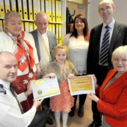 Elaine Way, Chief Executive for the Western Trust and Frank Orr, Area Manager, Northern Ireland Ambulance Service is seven year old Autumn Carey for her act of bravery. Also pictured is Heather Dillion (Grandfathers partner),  Robert Carey (Grandfather), proud mum Aine Carey and Gerard Guckian, Chairman of the Western Trust at the Celebratory Event held in Elaine Ways office, Altnagelvin Hospital.