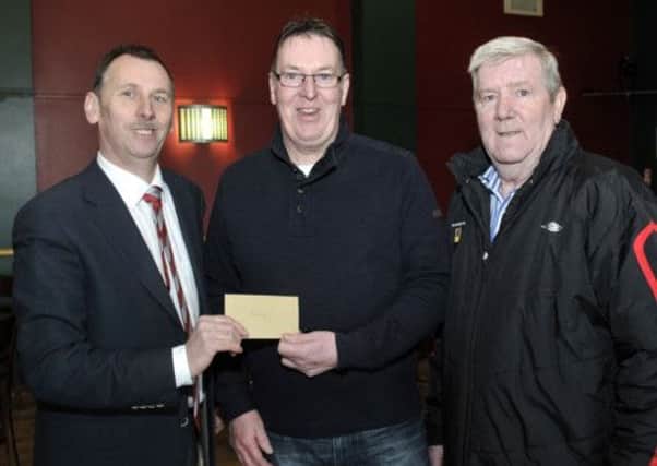 Terry Curran of Q Cabs presented Banbridge Town Chairman Andrew Cully with sponsorship of the match ball for Saturdays match with Rathfriland Rangers, included is Dan Buchanan  © Edward Byrne Photography INBL12-234EB